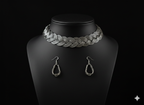 Detailed view of handcrafted oxidised silver braided hasli set with earrings displayed on bust stand
