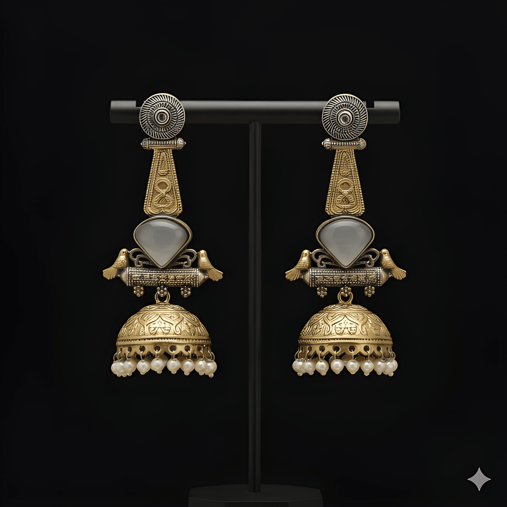Antique gold bird motif jhumka earrings displayed on black stand
