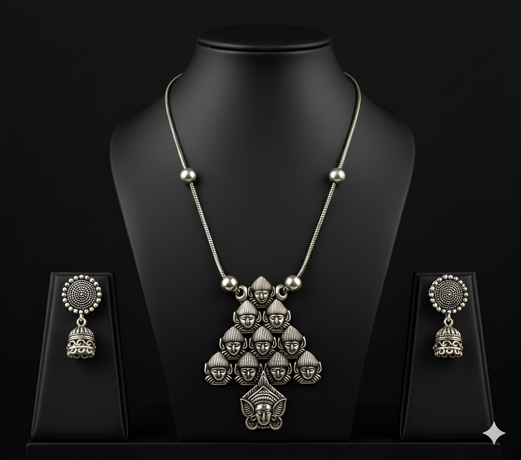 Detailed view of handcrafted oxidised silver deity pendant neckpiece displayed on bust stand
