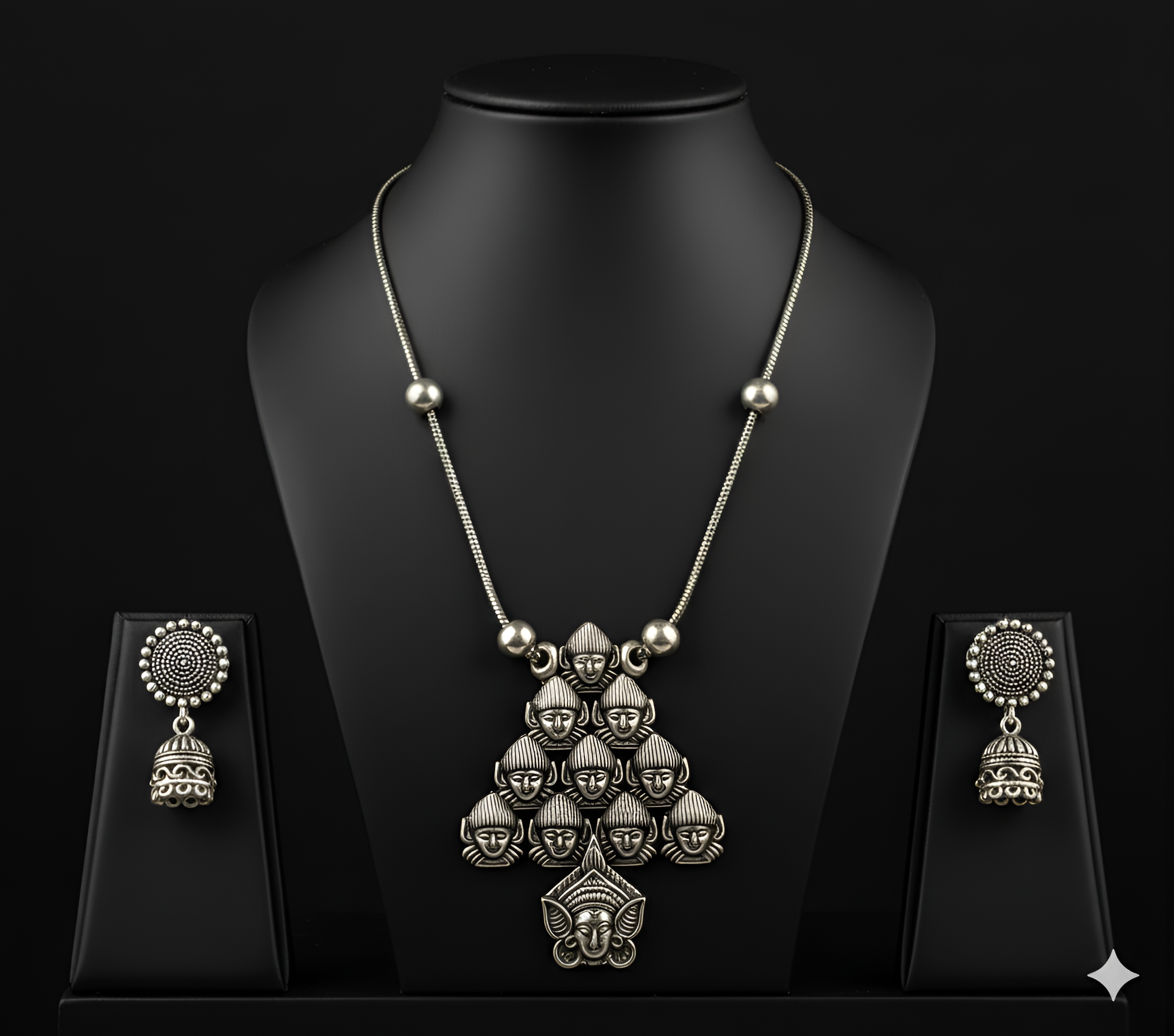 Detailed view of handcrafted oxidised silver deity pendant neckpiece displayed on bust stand
