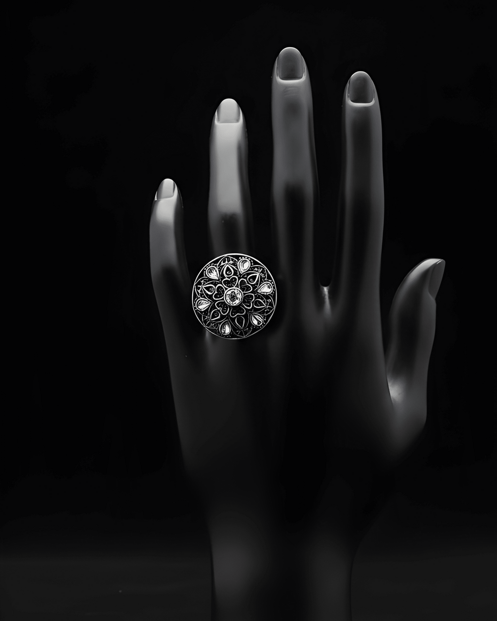 Handcrafted mandala stone statement ring with intricate detailing on black hand display
