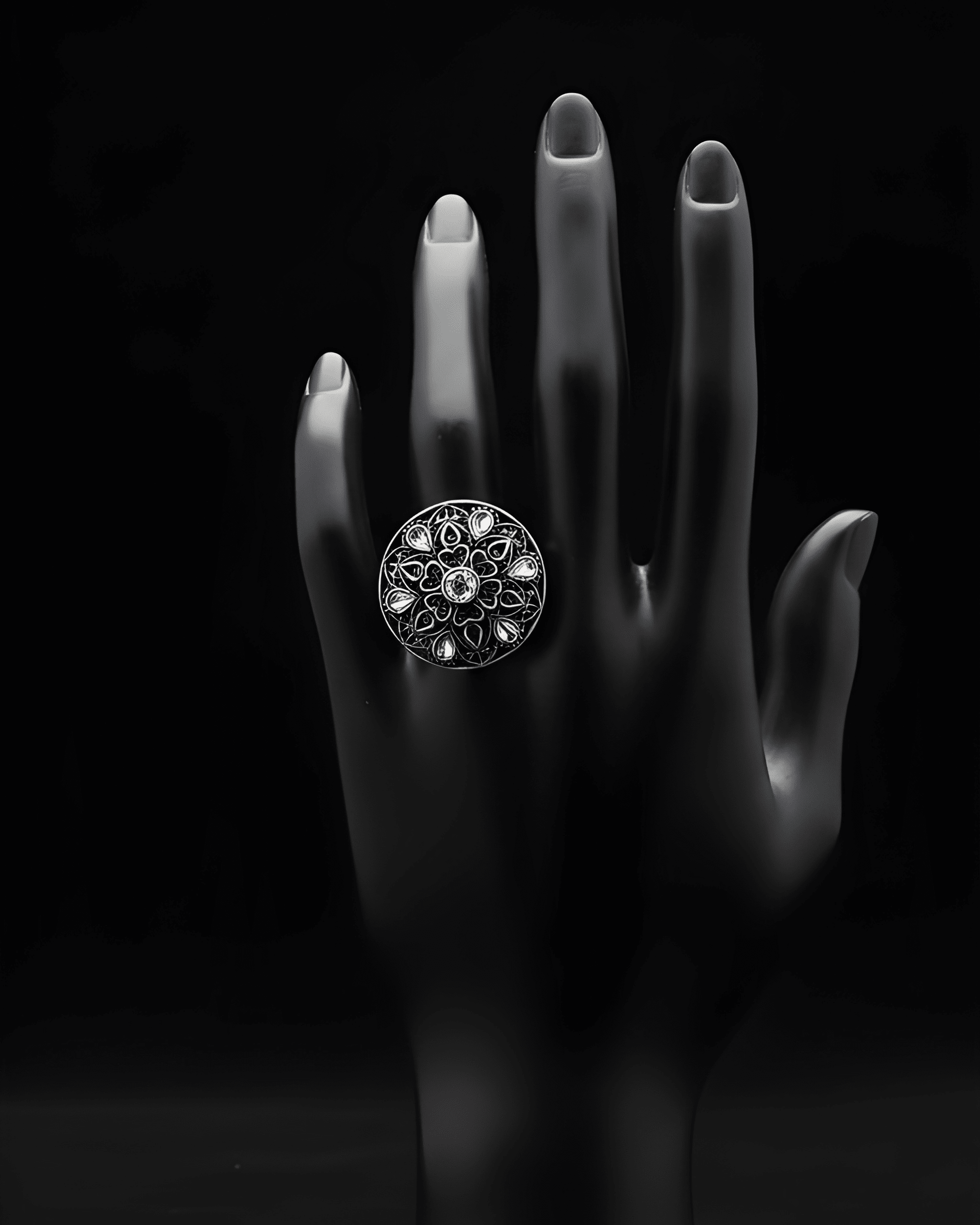 Handcrafted mandala stone statement ring with intricate detailing on black hand display