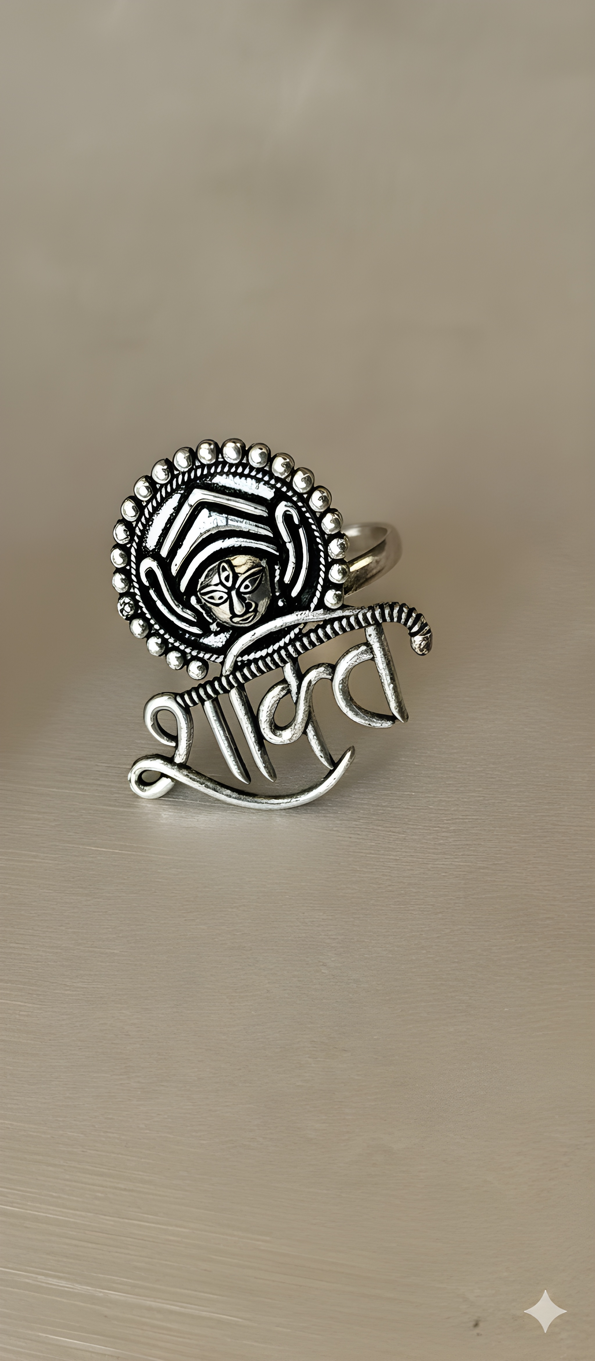 Shakti motif oxidised silver statement ring with sculpted detailing on golden background