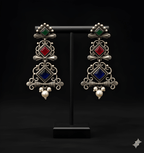 Multi-tier chandelier dangler earrings displayed on black stand
