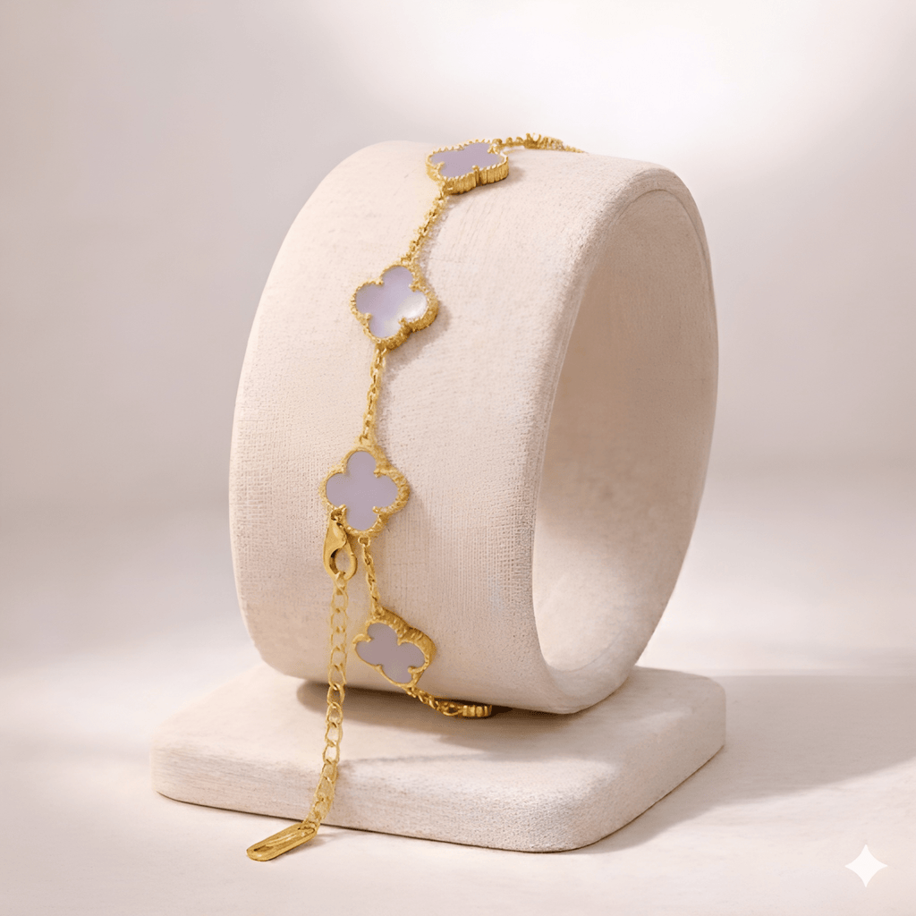 Lavender clover gold bracelet on minimal ivory jewellery stand
