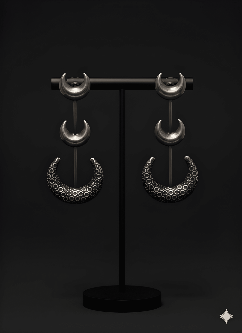 Chandra crescent statement earrings displayed on black stand in dark antique finish
