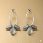 Leaf drop earrings with teardrop stone on golden background
