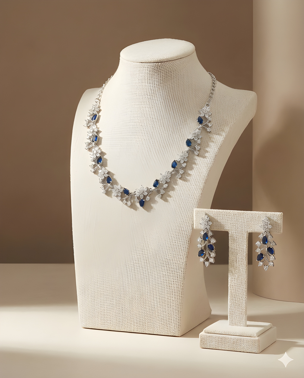 Silver sapphire pear crystal necklace set on ivory bust stand with earrings