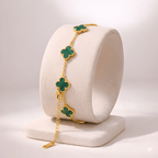 Emerald green clover bracelet displayed on ivory stand
