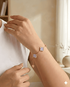 Woman wearing lavender clover gold bracelet on wrist in soft natural light