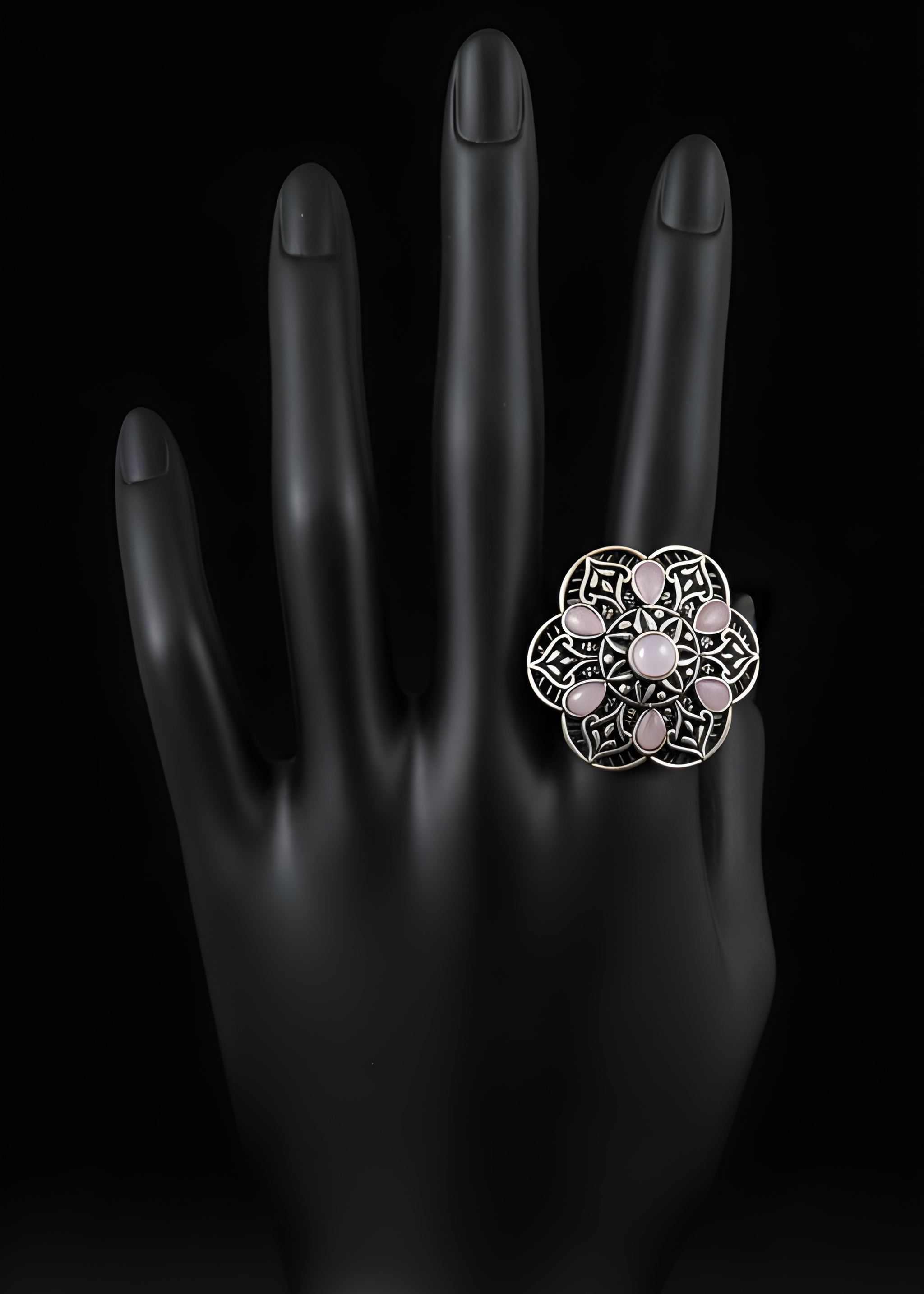 Handcrafted mandala stone statement ring with intricate detailing on black hand display