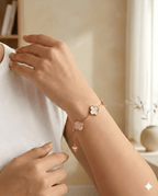 Woman wearing blush pink clover gold bracelet on wrist in soft natural light | Kayahh Jewels