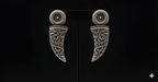 Oxidised silver carved dagger drop earrings displayed on black stand
