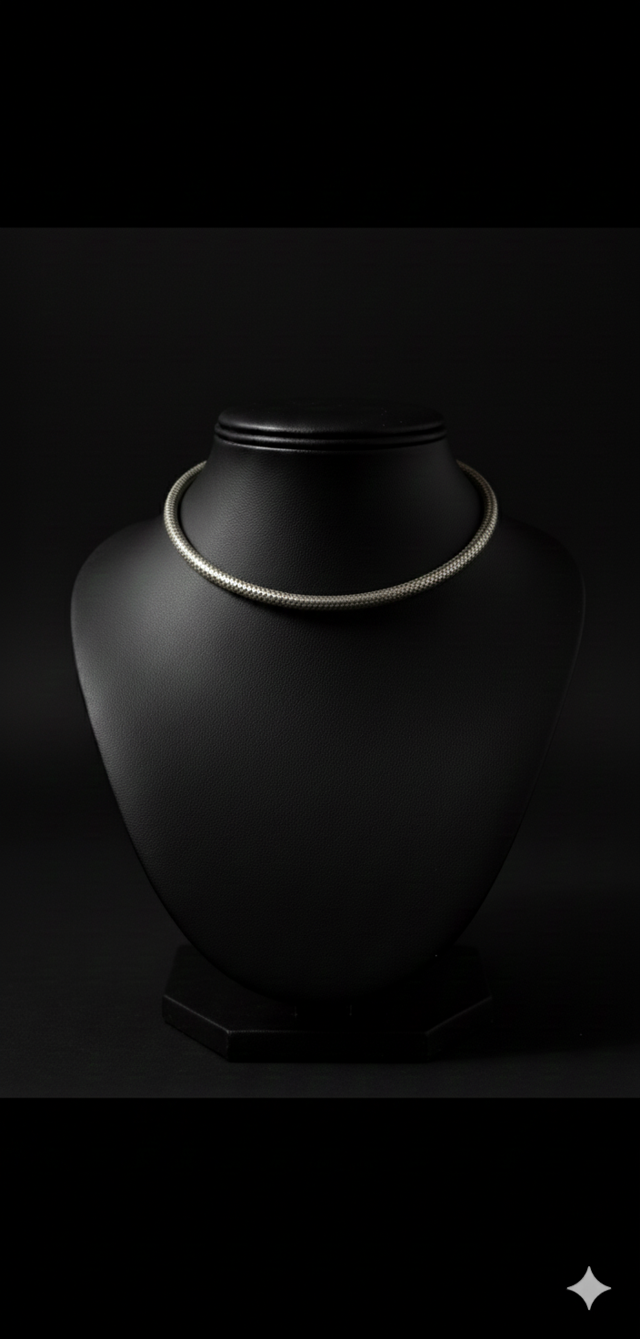 Detailed view of handcrafted oxidised silver hasli neckpiece displayed on bust stand
