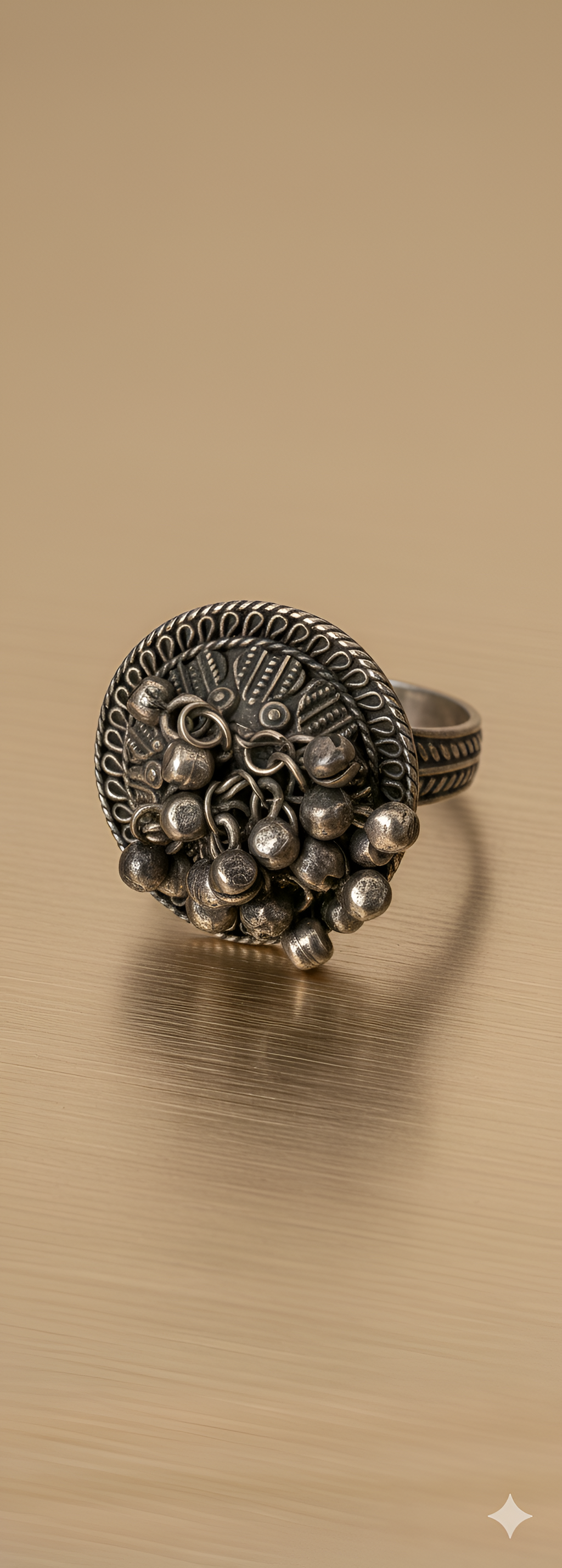 Handcrafted ghungroo medallion statement ring in oxidised silver finish on golden background