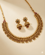 Devika temple ruby emerald necklace set with matching jhumka earrings flat lay