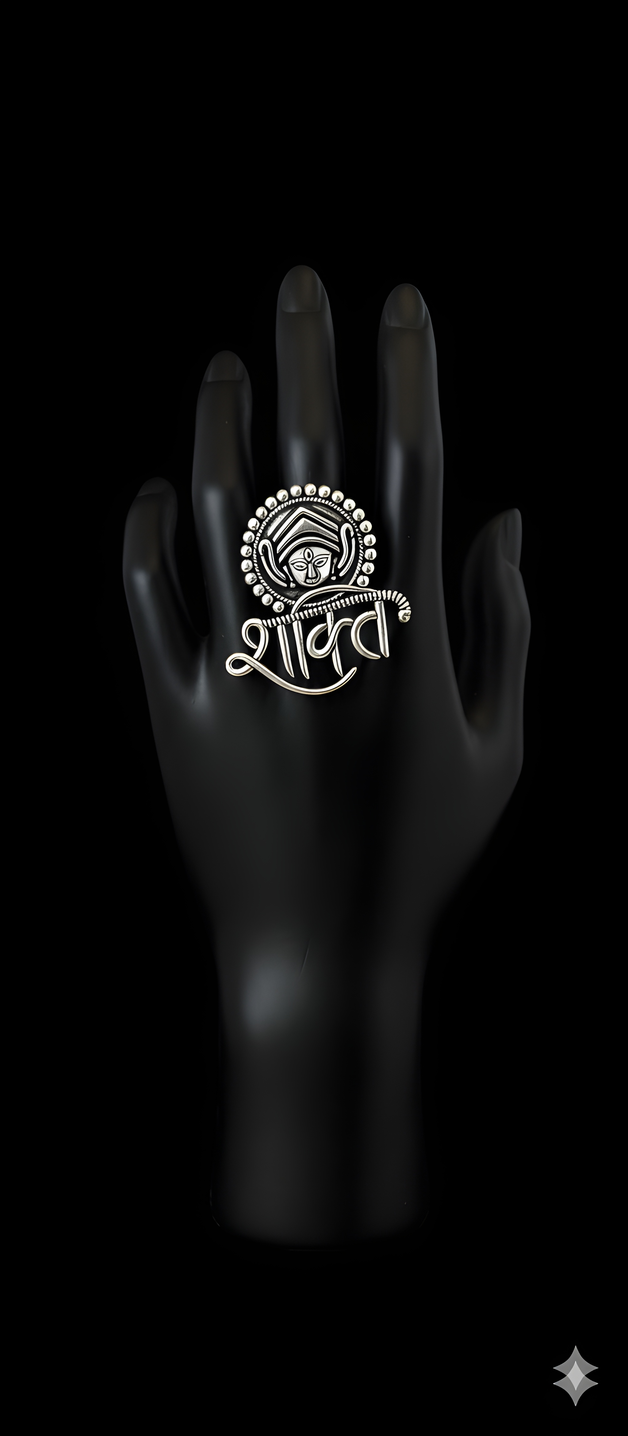 Handcrafted Shakti motif oxidised silver statement ring displayed on black hand