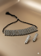 Handcrafted oxidised silver beaded choker neckpiece with matching earrings on golden background
