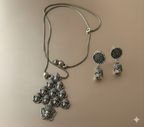 Handcrafted oxidised silver deity pendant neckpiece with bead-accented chain on golden background
